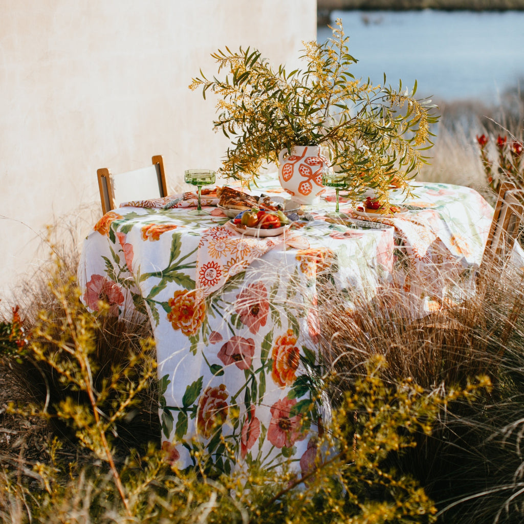 Hand painted pink and orange poppies and carnations, with fresh green leaves and stems.